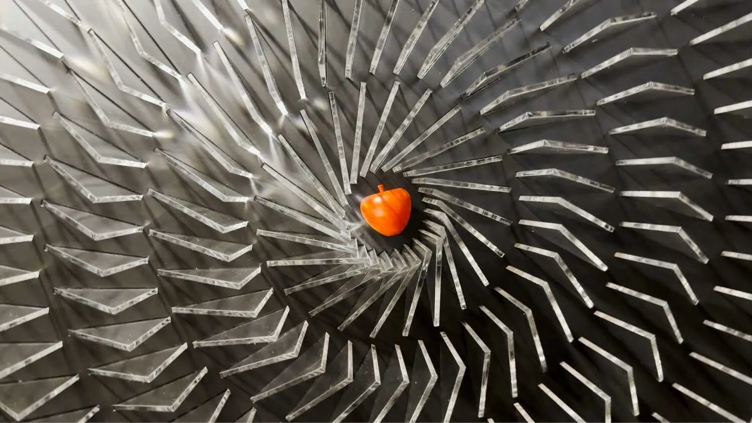A spiral of clear panels surrounding a warm central object.